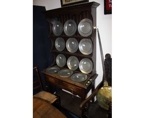 A small Georgian two drawer kitchen dresser with a two shelf plate rack 