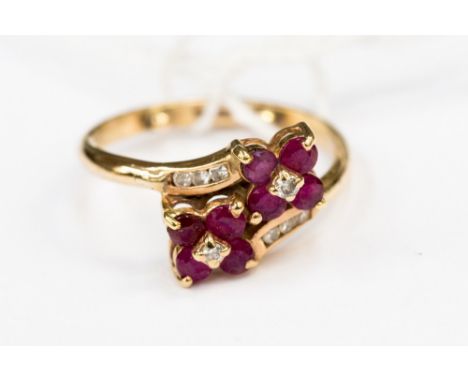 An 18ct gold, ruby and diamond double flower head cluster ring, ring size O,gross weight approx 3.6 grams 