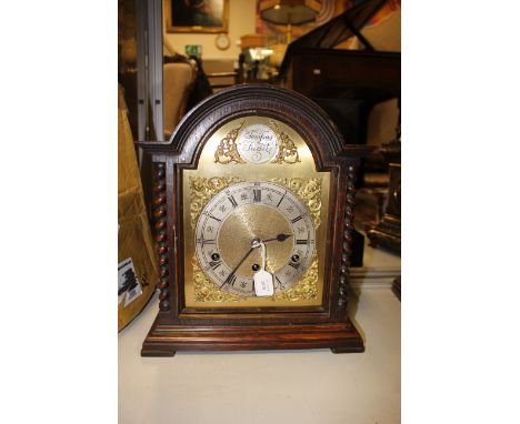 A table clock, late 19th Century working, Westminster chime in solid wood case, damage to glass door, with key and pendulum 