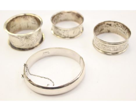 A Charles Horner silver napkin ring, Chester 1921, with two further silver napkin rings and a silver bangle, approx total wei