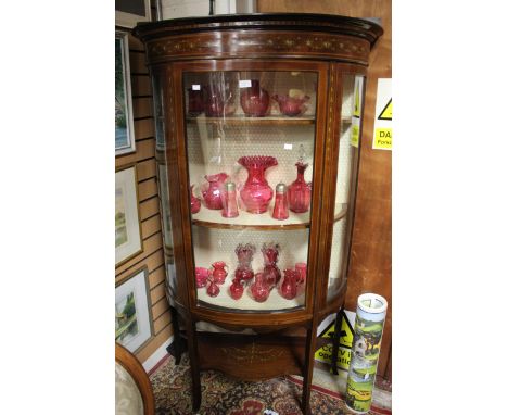 An Edwardian three shelf tall bow fronted mahogany display cabinet with Adams style painted top rail 