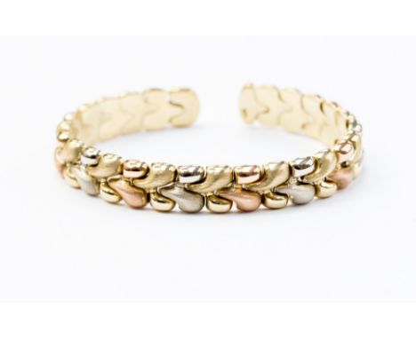 A 9ct three colour gold torque bangle, 20.5 grams approx 