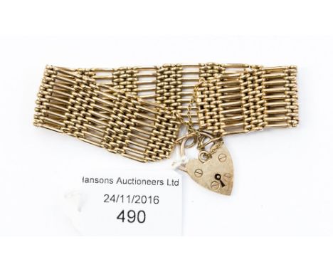 A 9ct gold 9 bar gate bracelet with padlock fastener, 32.4 grams approx 