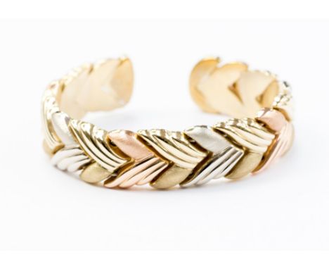 A 9ct three colour gold torque bangle, entwined chevron pattern, 28.7 grams approx 