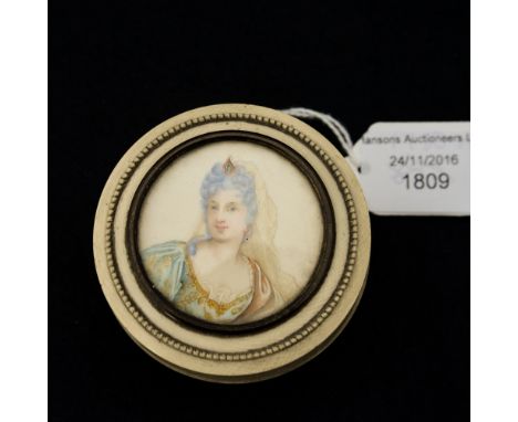 A 19th Century circular ivory lidded box, the pull-off lid inset with a portrait miniature of a lady in 18th Century costume,