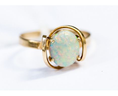 A nine carat gold ring set with an opal