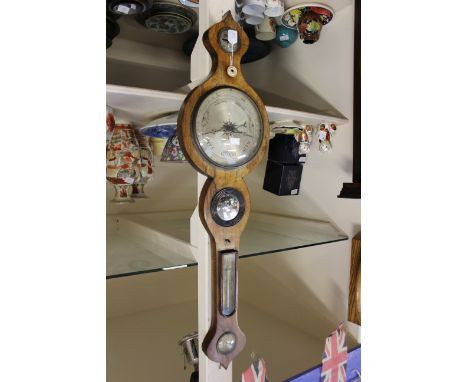A figured walnut banjo barometer, circa 1820
