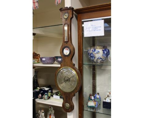 A 19th Century mahogany cased banjo barometer and thermometer, with spirit gauge to bottom section