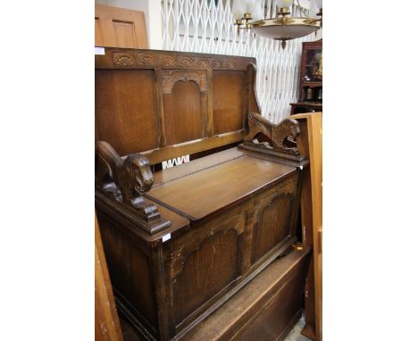 A Jacobean style monks bench with Lion carved arms 
