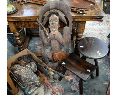 A box of carved wooden tribal wall masks and other ethnic items, including spear, sticks, axe, etc and two wooden stools 