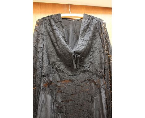 A black lace mid 1930s evening dress with long sleeves, 'V' neckline and bow (1) 
