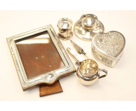 An Indian white metal heart-shape box, embossed with native animals and trees; an Edwardian/George V silver photo frame; silv