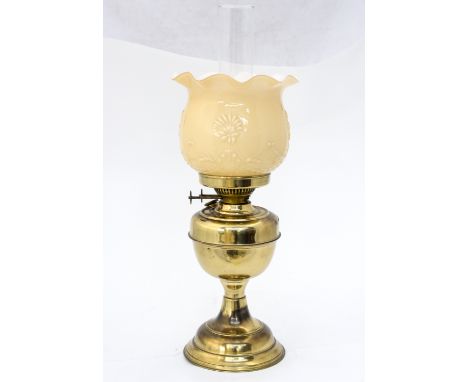 A brass and glass oil lamp, the moulded and cased shade with Art Nouveau floral design double wick 