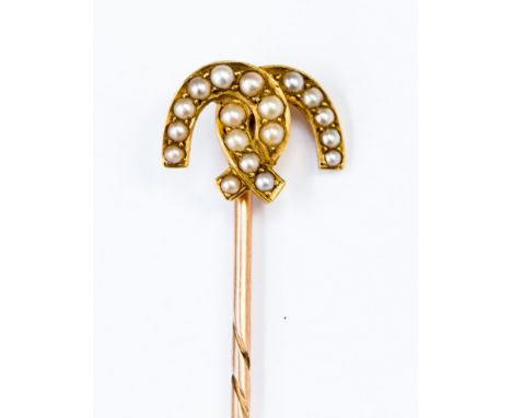 A rose metal and yellow metal cravat/stick pin Edwardian set with seed pearl in linked horseshoes, gross weight 2.3 grams app