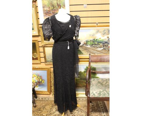 A 1930s black lace evening frock with a lace bolero and a long chiffon sash; together with it's own underskirt , panniers, cu