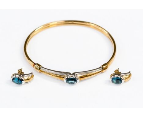 A blue topaz set 9ct white and yellow gold bangle and matching earrings, gross weight 15.6 grams approx 