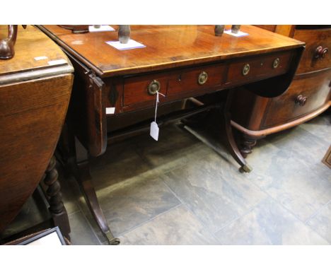 An early 19th Century mahogany and rosewood cross banded sofa table, fitted with two drawers 