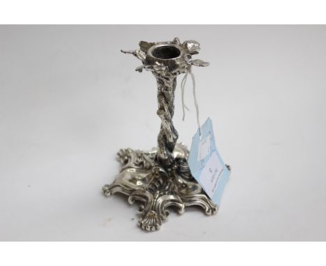 A Elkington and Co silver plated candlestick, realistically cast as intertwined branches on a shell scroll Rococo base, 1853 