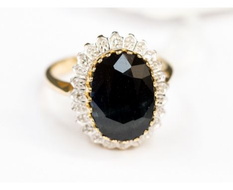 Sapphire and 9ct gold ring with illusion set diamond surround, ring size P½ sapphire size 8mm by 5mm approx, gross weight app