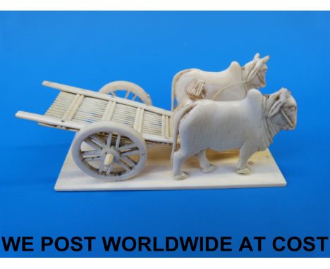 An Indian ivory model of two buffalo pulling a cart with driver 