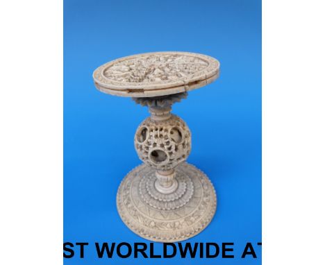 A Chinese ivory stand with carved top and puzzle ball knop