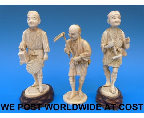 Three Japanese Meiji period ivory okimono of peasants two on wooden bases (two 17cm, one 15cm tall)  