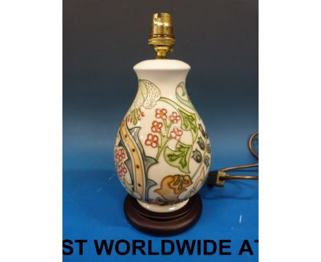 A Moorcroft lamp base with floral decoration on a cream ground - PAT test passed