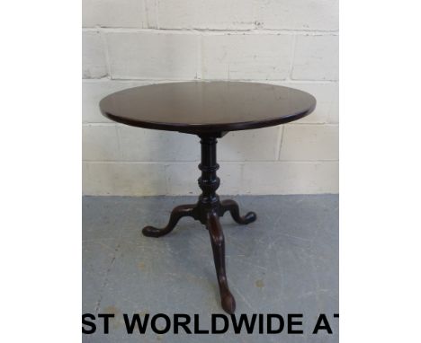 A 19thC circular mahogany tilt-top table with birdcage mechanism, raised on a central turned wrythen support and shaped tripo