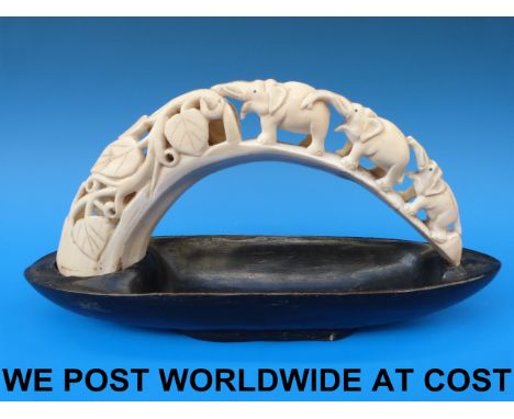 A hippopotamus ivory tusk inset into an ebony bowl