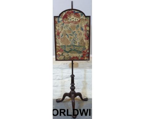 A 19thC pole screen, the tripod base finely carved terminating in ball and claw feet with tapestry panel.