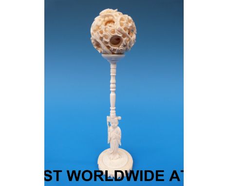 A Chinese ivory puzzle ball and stand