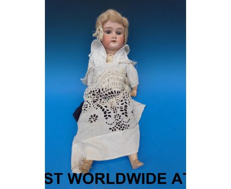 An Armand Marseille doll in period costume "11.5 m" impressed to neck