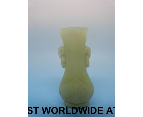 A Chinese jade vase of small proportions with elephant head handles (5cm high) 