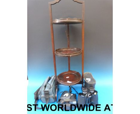 A folding cake stand together with a Protax camera and a pair of Halina 16 x 50 binoculars
