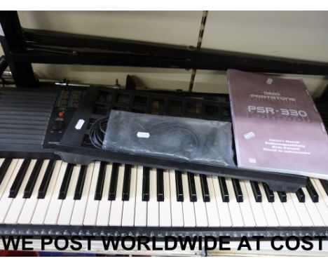 A Yamaha PSR 330 together with instruction manual and stand