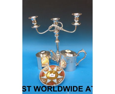 A silver plated teapot, octagonal tea caddy, a candelabra, two brass and plastic Penguin Plates