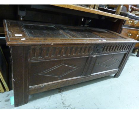 An 18thC oak coffer having three panel top and two panel front with carved diamond motifs (width 135cm, depth 50cm, height 54