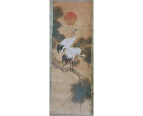 A Chinese scroll picture of two white herons upon a pine tree, ink on silk with inscription and seal (125cm x 42cm)