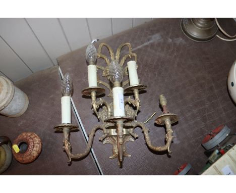 A five light wall sconce with flower head decoration 