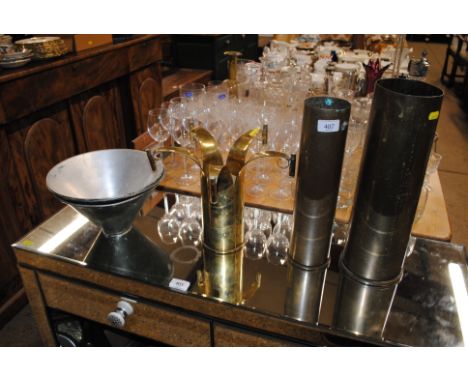 A brass Trench Art shell case; two other brass shell cases and three metal light shades 