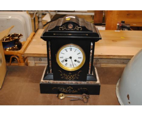 A Victorian slate mantel clock with eight day movement 