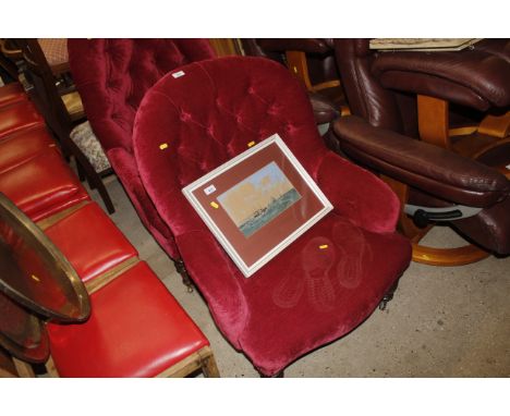 A late Victorian button back upholstered armchair 