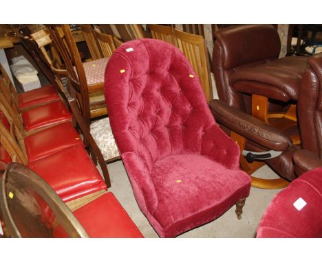 A late Victorian button back upholstered armchair 