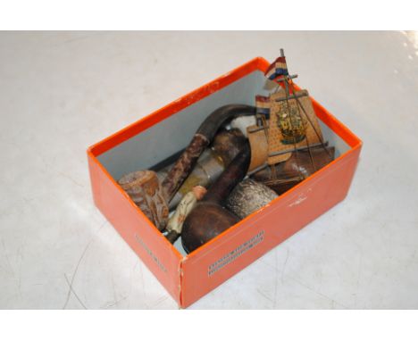 A box containing various pipes and a lighter 