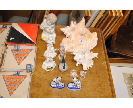A pair of Italian blanc de china cherub figures, a Nao figure, two shells and a quantity of miniature Staffordshire cat ornam
