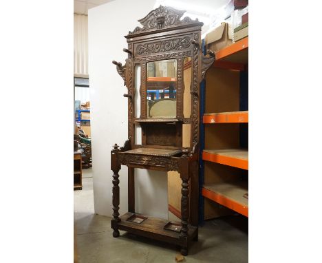 Victorian Oak Hall Stand / Hallstand, heavily carved with foliage scrolls and green man mask, with central bevelled edge mirr