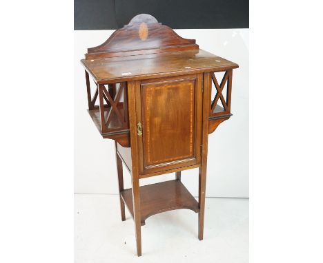 Edwardian Mahogany Inlaid Cabinet of Art Nouveau form, the single panel door flanked by overhanging shelves, shelf below, 63c