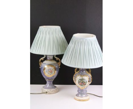 Two early 20th century lustre table lamps of urn form, with gilt details, one being decorated with a classical printed scene 