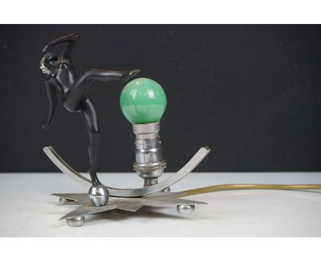 Art Deco wall lamp having a star shaped back plate with a nude female figure and green light bulb. Back plate measures 18 x 1