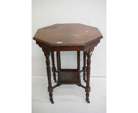 Early 20th century Mahogany Octagonal Occasional Table with central under-shelf, raised on turned ringed supports and castors